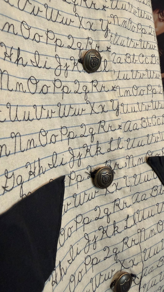 details of cursive writing teacher vest buttons