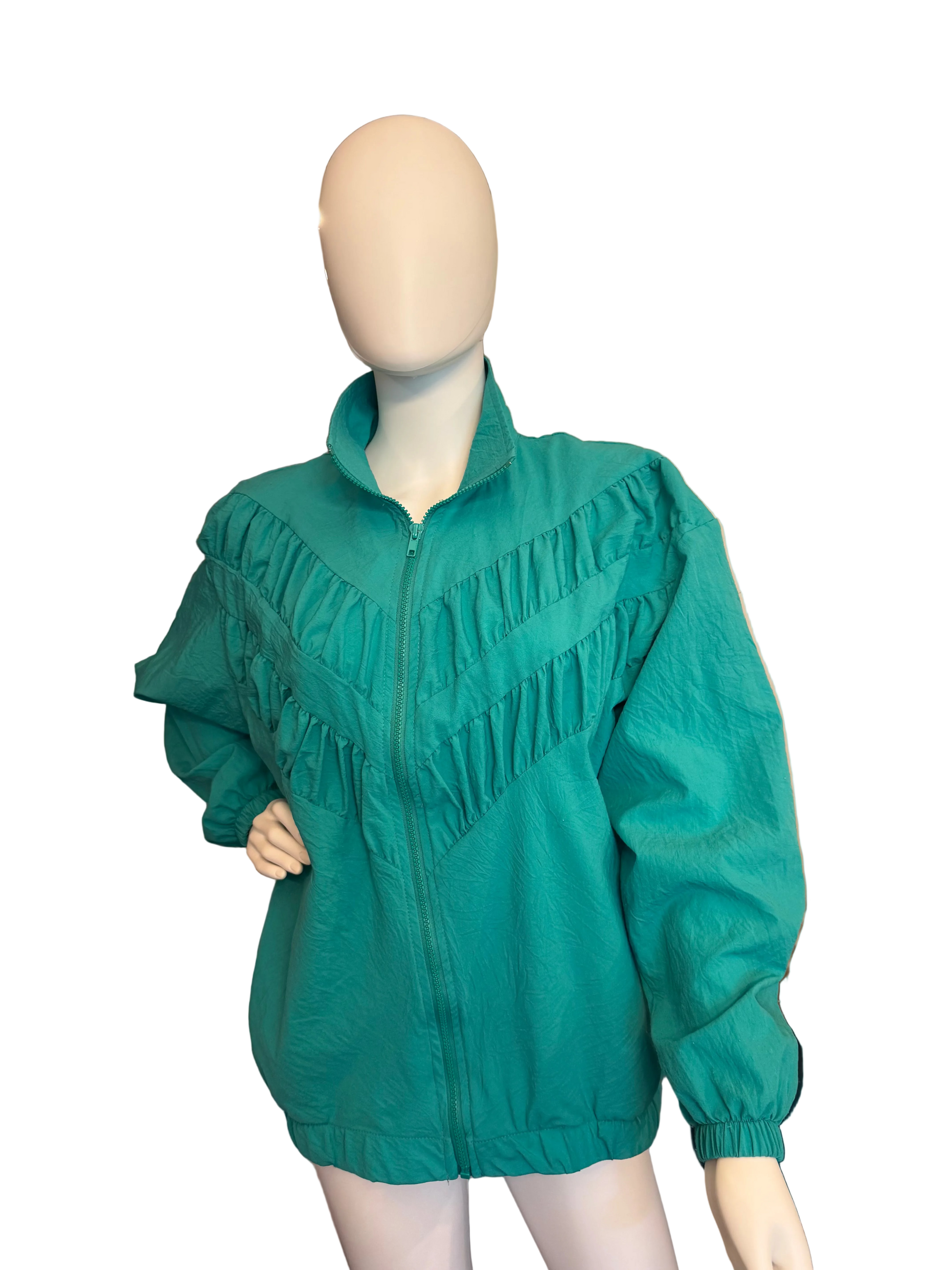 Green jacket on a mannequin in a room with a staircase