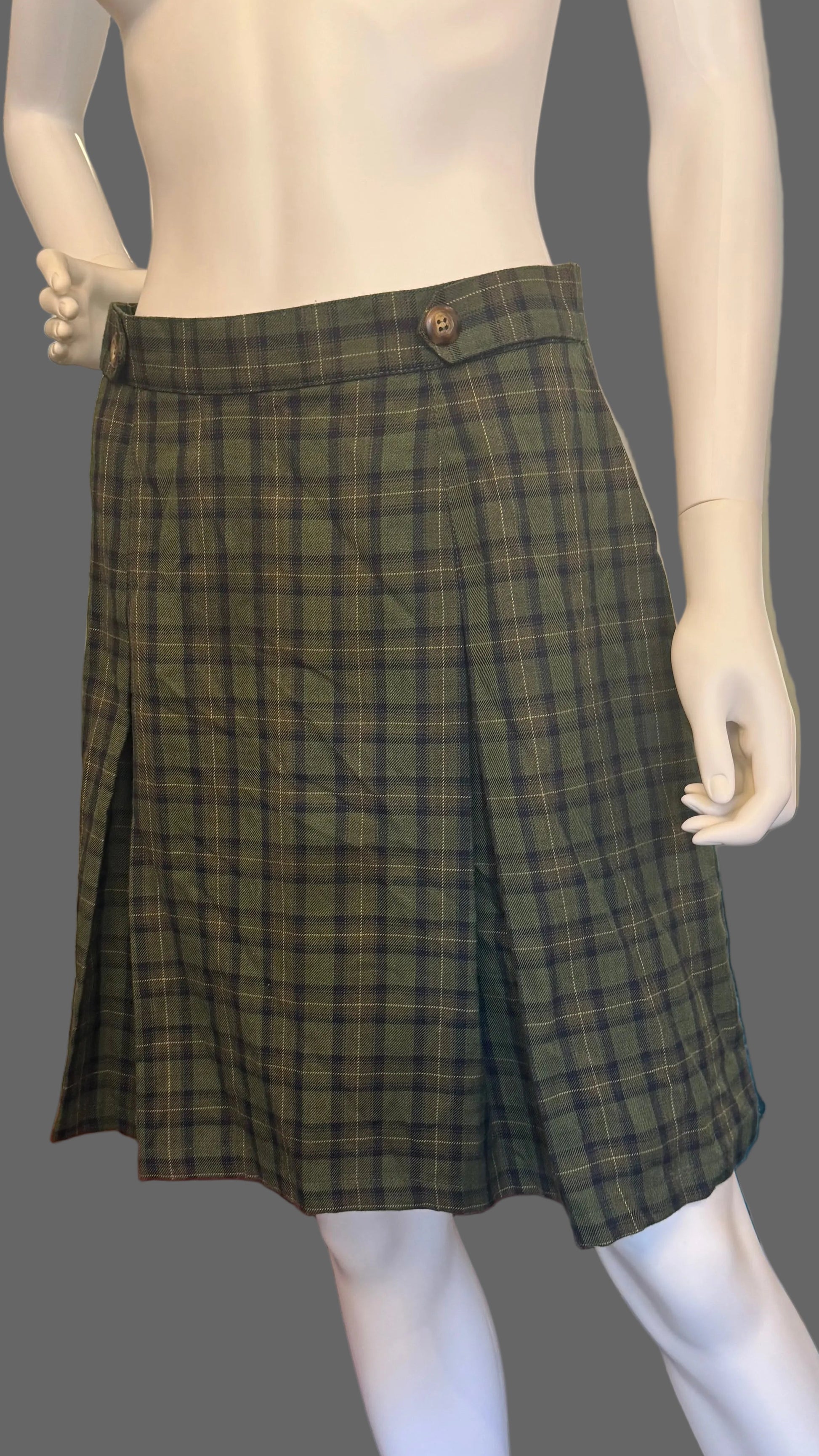 Mannequin wearing a green plaid skirt in a home setting