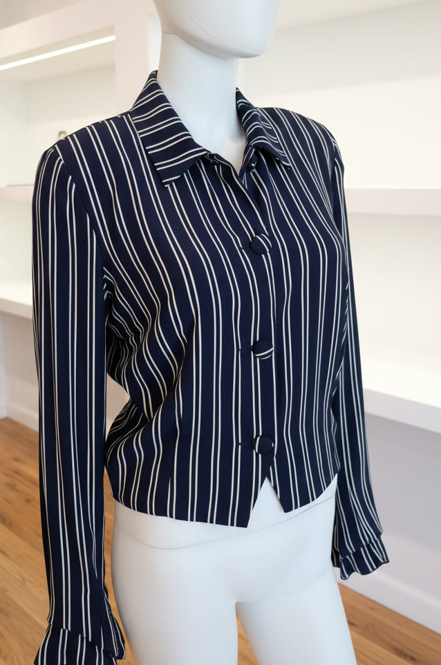 Mannequin wearing a black and white striped shirt in a room with furniture and decor.